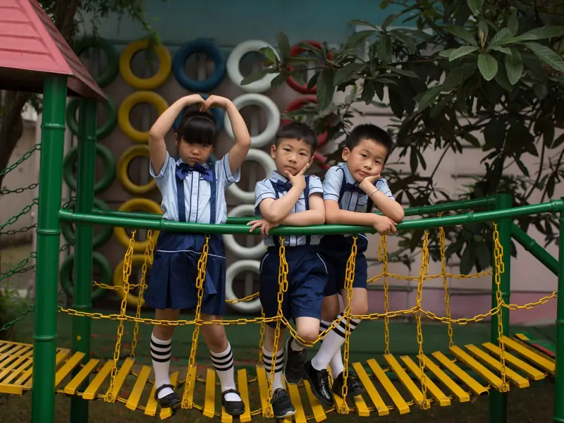 The playground at break, with children climbing and running.